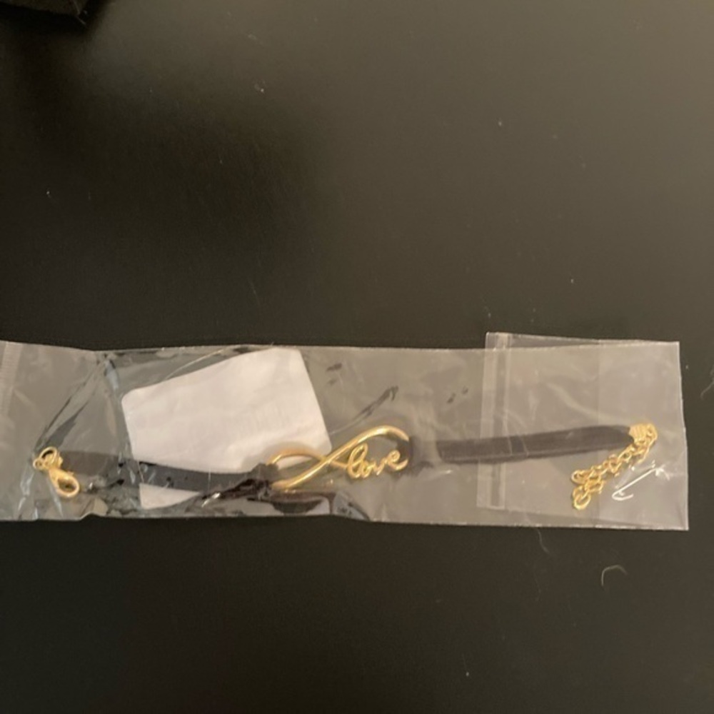 Still in plastic. Bracelet with infinity love golden design.